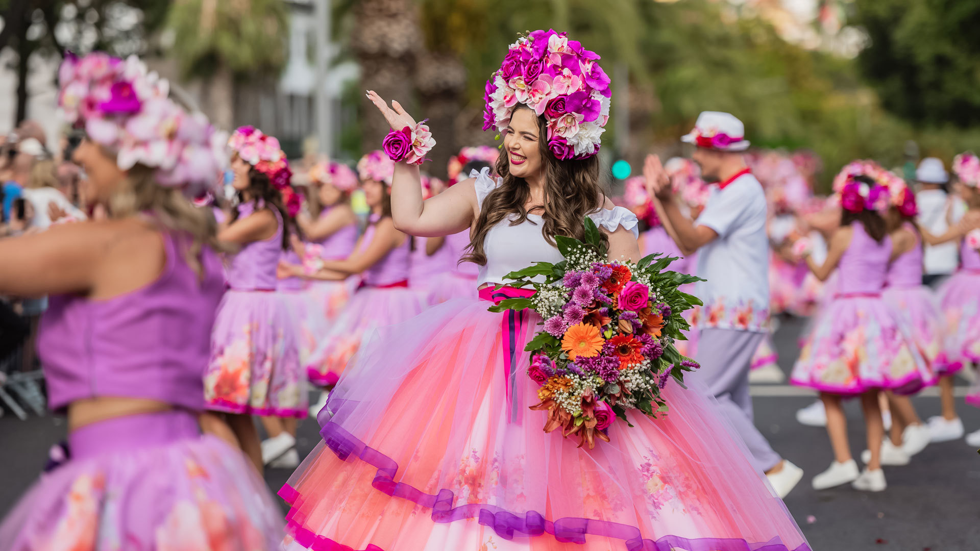 Flower Festival Madeira 2024 floral float with performers in elaborate flower costumes Avenida do Mar