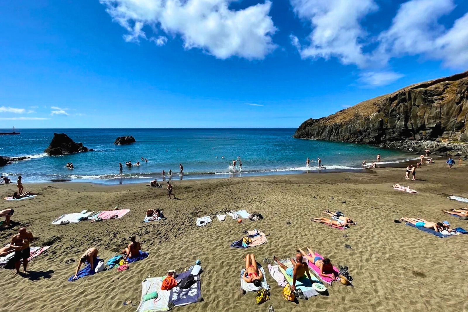 Prainha natural dark sand beach Madeira east of Funchal sheltered cove